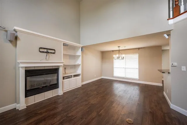 a view of an empty room with a fireplace and a window