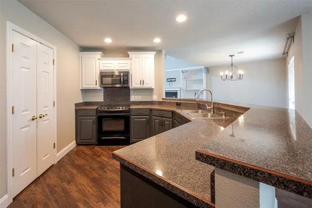 a kitchen with a sink and stainless steel appliances