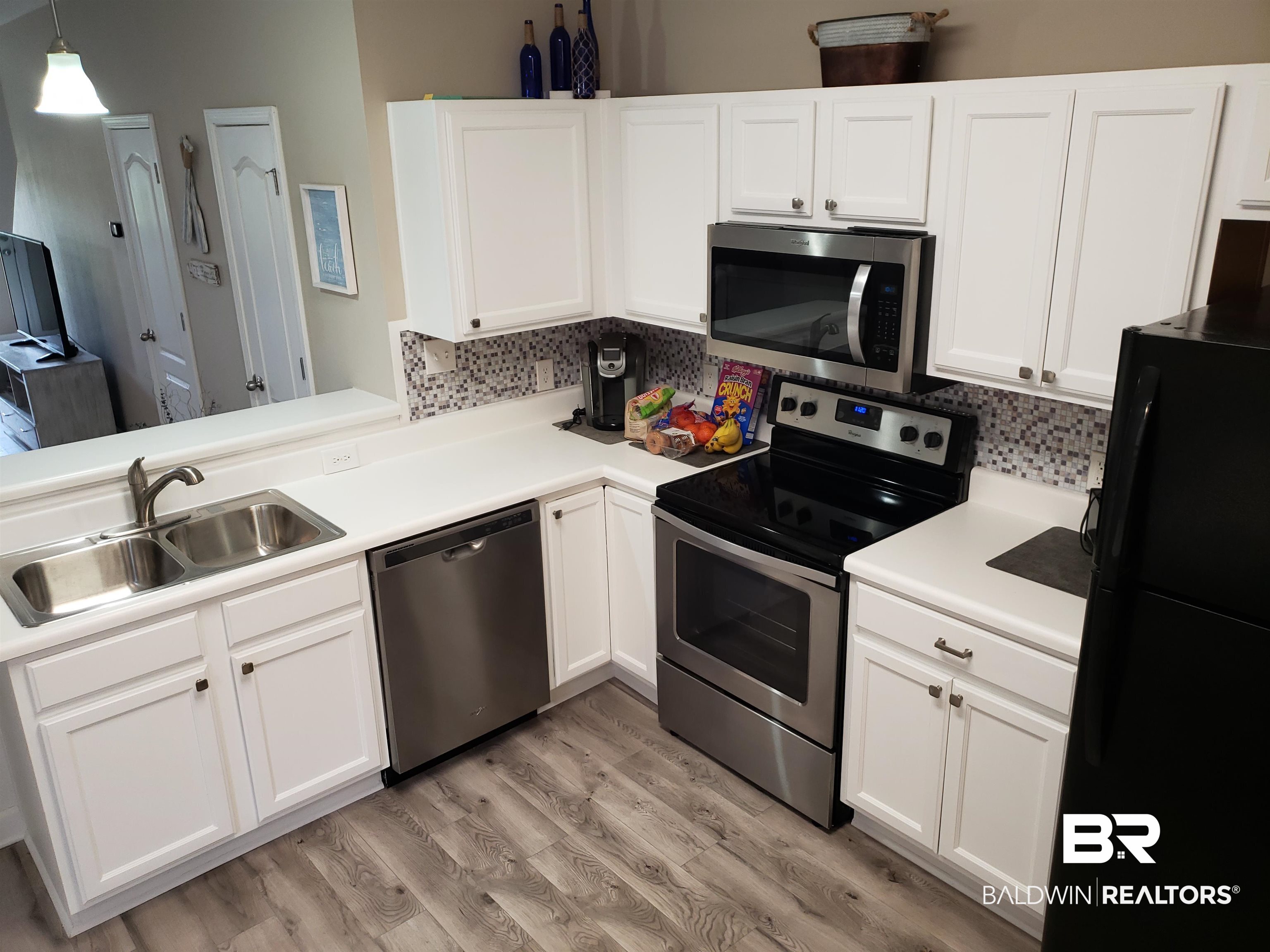 2006 Shelene Way, Unit 2006 Foley, AL 36535 - Photo 3 of 29 Kitchen with a sink, tasteful backsplash, Whirlpool appliances with stainless steel finishes that convey with property, and white cabinets