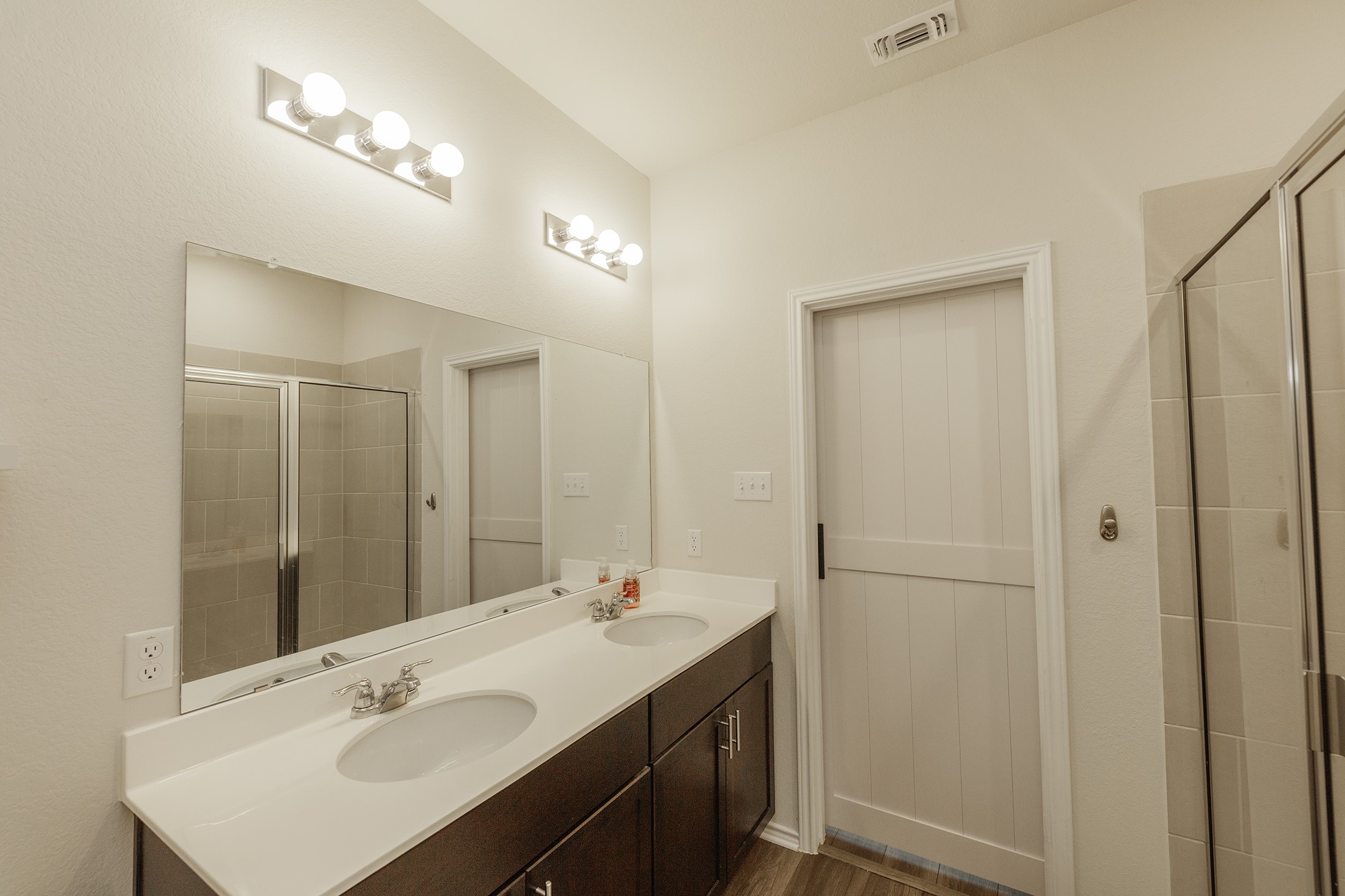 125 Janice Road Taylor, TX 76574 - Photo 11 of 26 Dual sink vanity with white countertop and dark wood-finish cabinetry