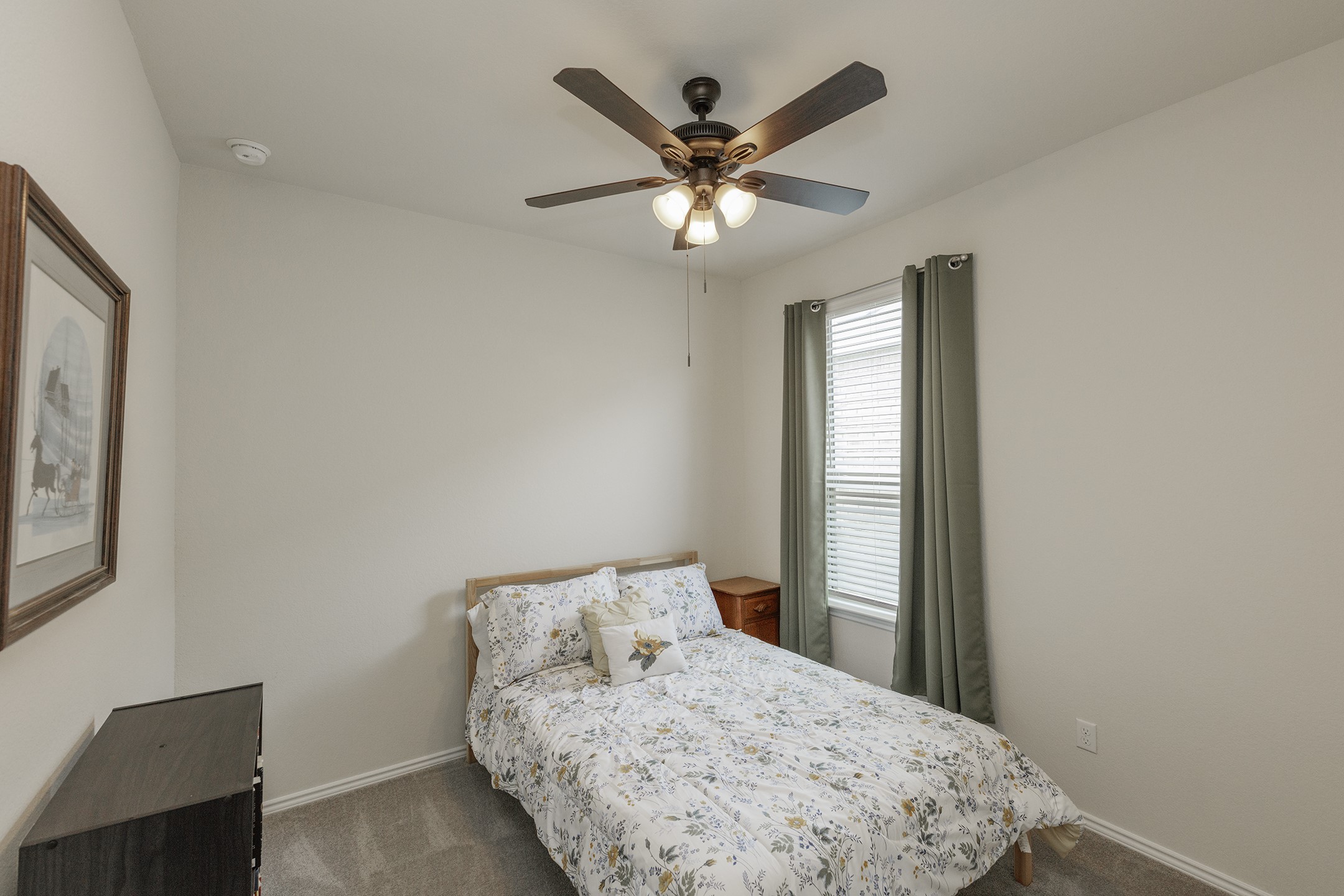125 Janice Road Taylor, TX 76574 - Photo 19 of 26 Neutral-toned walls complement plush grey carpeting