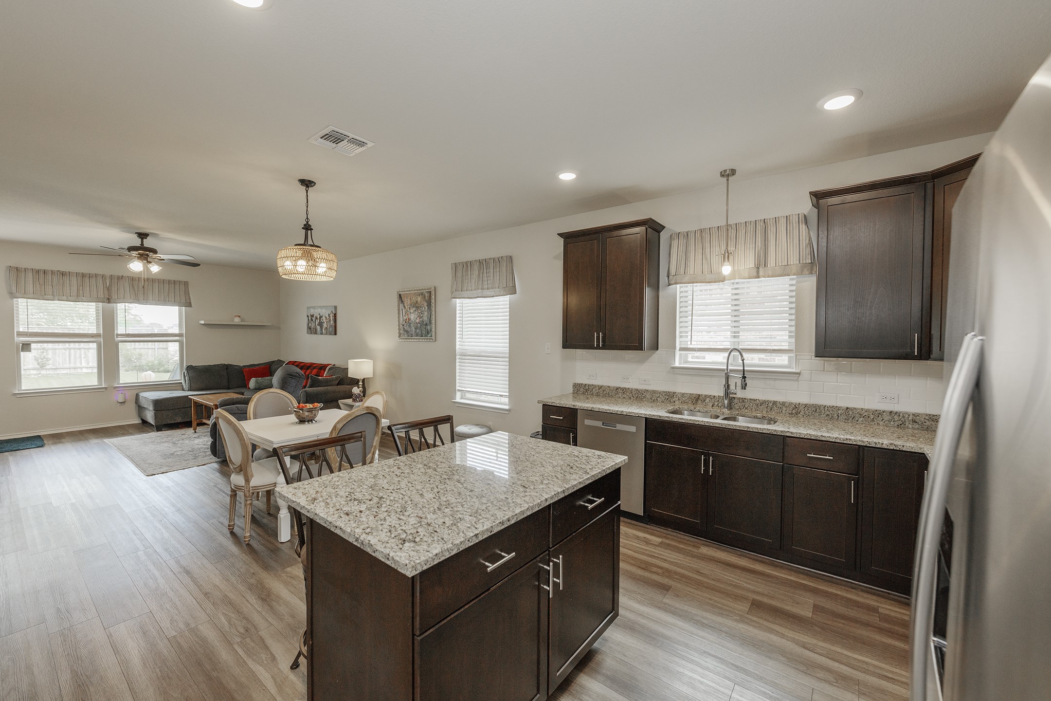 125 Janice Road Taylor, TX 76574 - Photo 2 of 26 Open-concept kitchen and living area featuring wood-finish flooring
