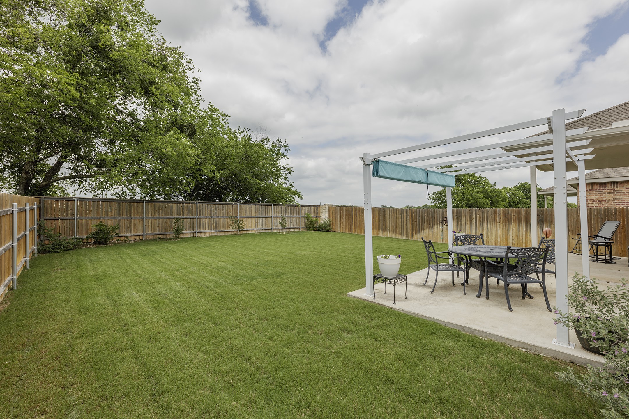 125 Janice Road Taylor, TX 76574 - Photo 21 of 26 Expansive backyard featuring a lush lawn and a wood privacy fence