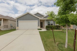 125 Janice Road Taylor, TX 76574 - Photo 23 of 26 Contemporary facade featuring gray vertical siding and light-colored stone accents
