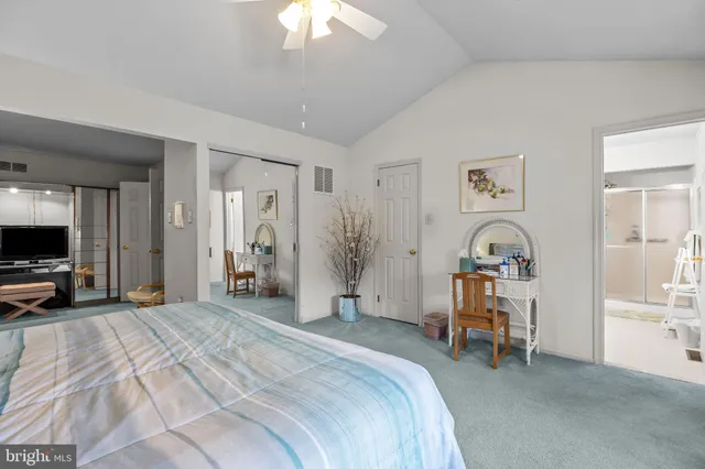 a bedroom with furniture and a flat screen tv