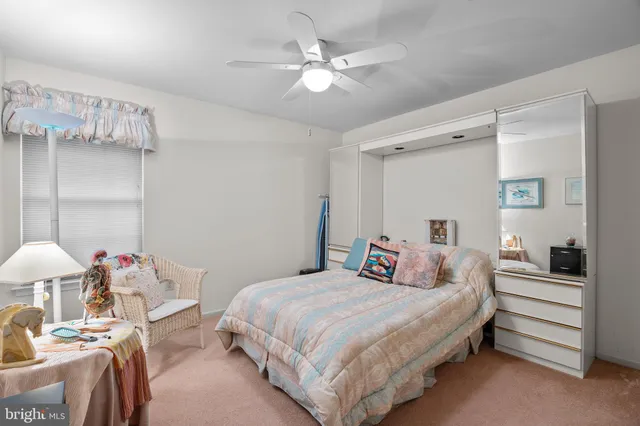 a bedroom with a bed and ceiling fan