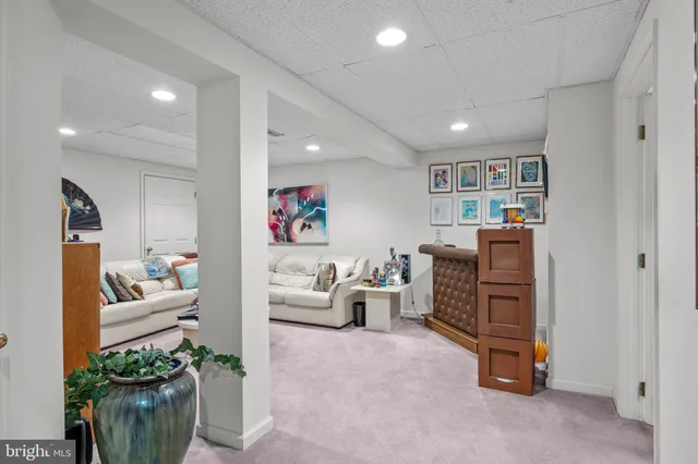 a living room with furniture and a bookshelf
