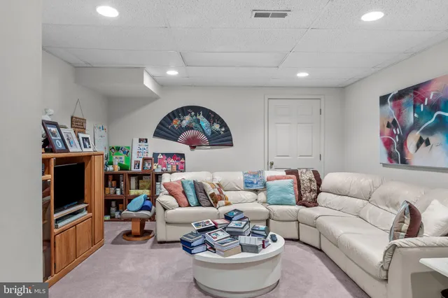 a living room with fireplace furniture and a flat screen tv