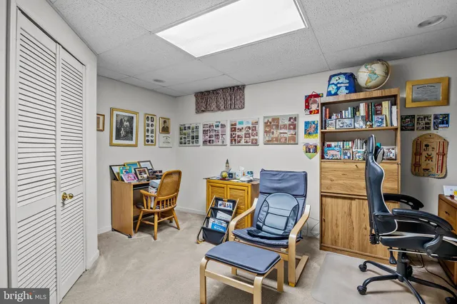 a living room with furniture and a piano