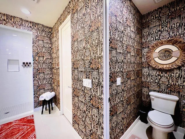a bathroom with a toilet and a shower curtain