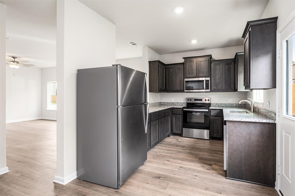 4256 Lava Frst Drive Dallas, TX 75241 - Photo 6 of 20 a kitchen with stainless steel appliances cabinets and a refrigerator