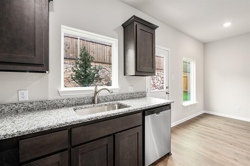 4256 Lava Frst Drive Dallas, TX 75241 - Photo 9 of 20 a kitchen with granite countertop stainless steel appliances a sink window and cabinets