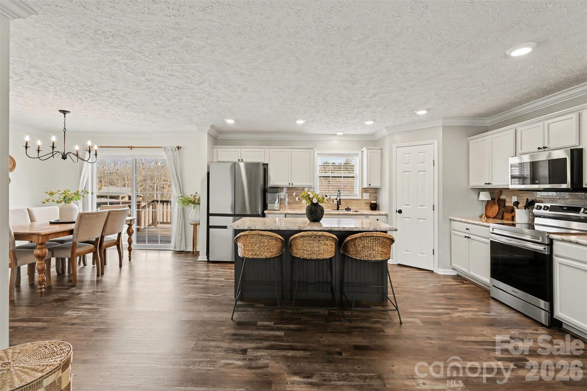 193 Back Acres Lane Kannapolis, NC 28081 - Photo 4 of 23 a large kitchen with kitchen island a sink table and chairs