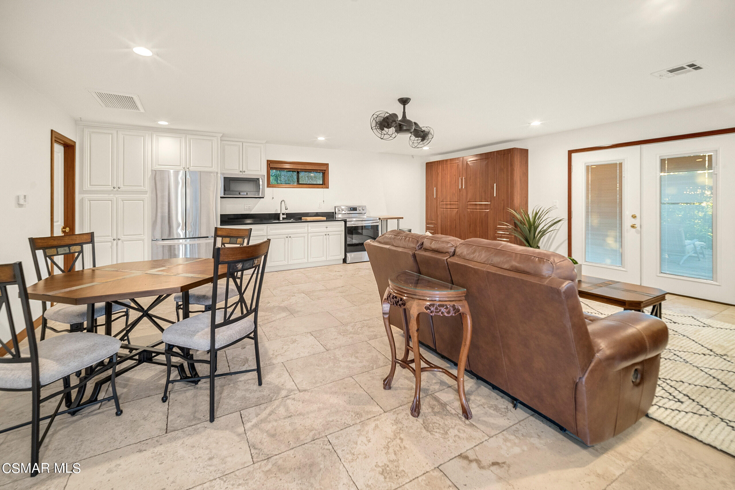 11875 Pradera Road Camarillo, CA 93012 - Photo 39 of 58 a living room with furniture and a dining table with kitchen appliances