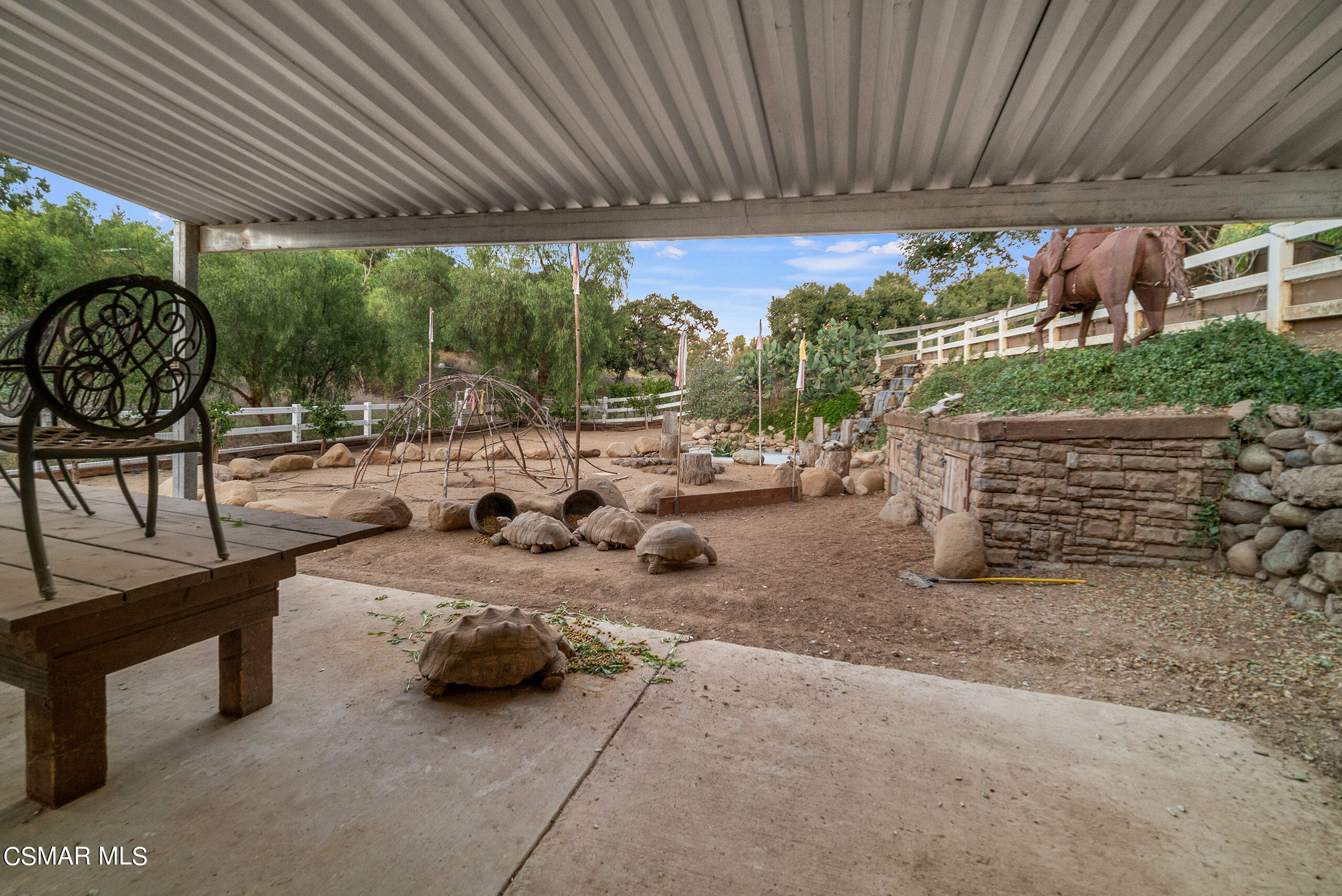 11875 Pradera Road Camarillo, CA 93012 - Photo 54 of 58 a view of a patio with a table and chairs under a large umbrella