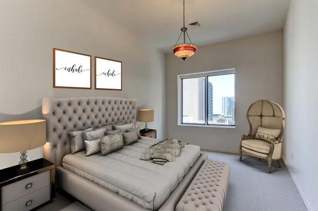 a bedroom with furniture and a window