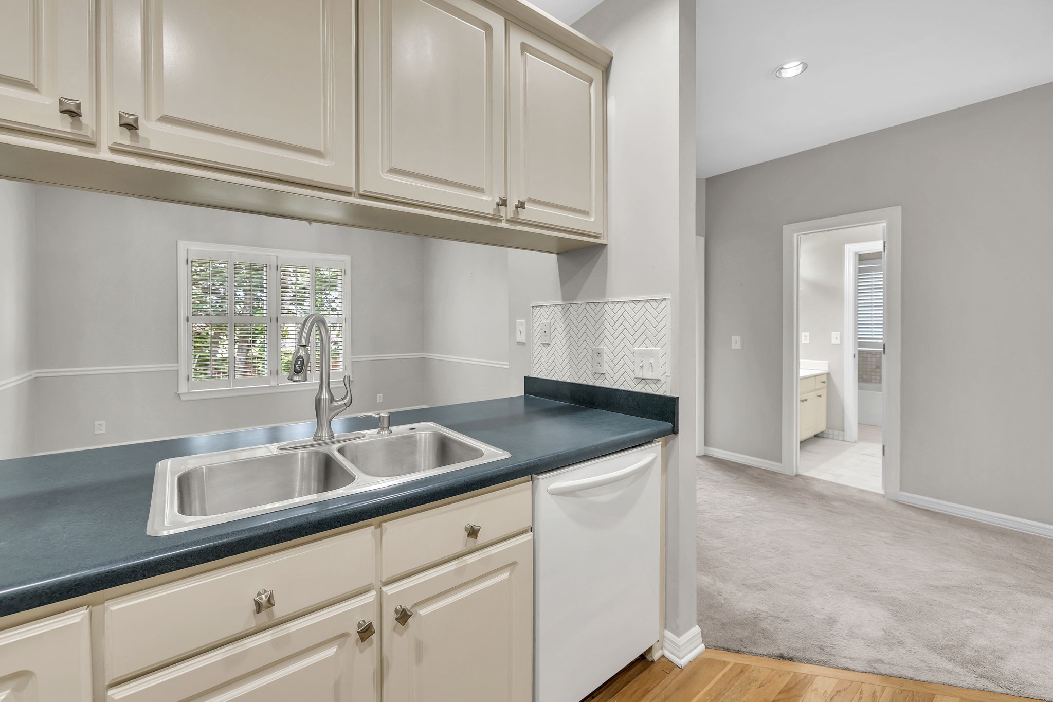 104 Hicks Road Nashville, TN 37221 - Photo 16 of 41 a kitchen with granite countertop a sink and white cabinets