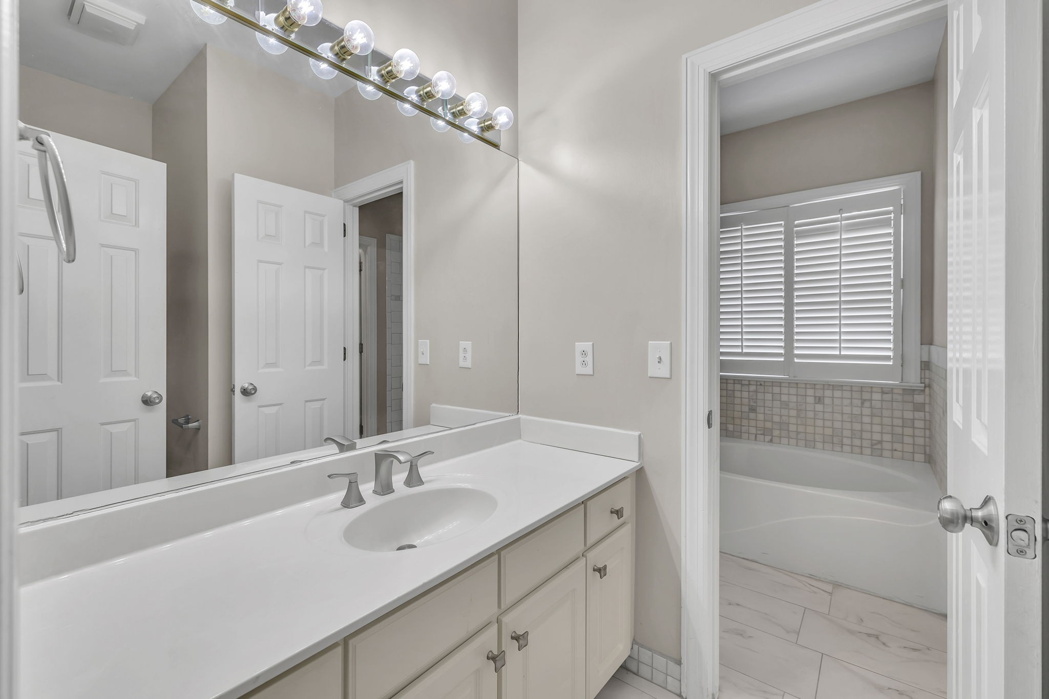 104 Hicks Road Nashville, TN 37221 - Photo 23 of 41 a bathroom with a sink a mirror and a shower