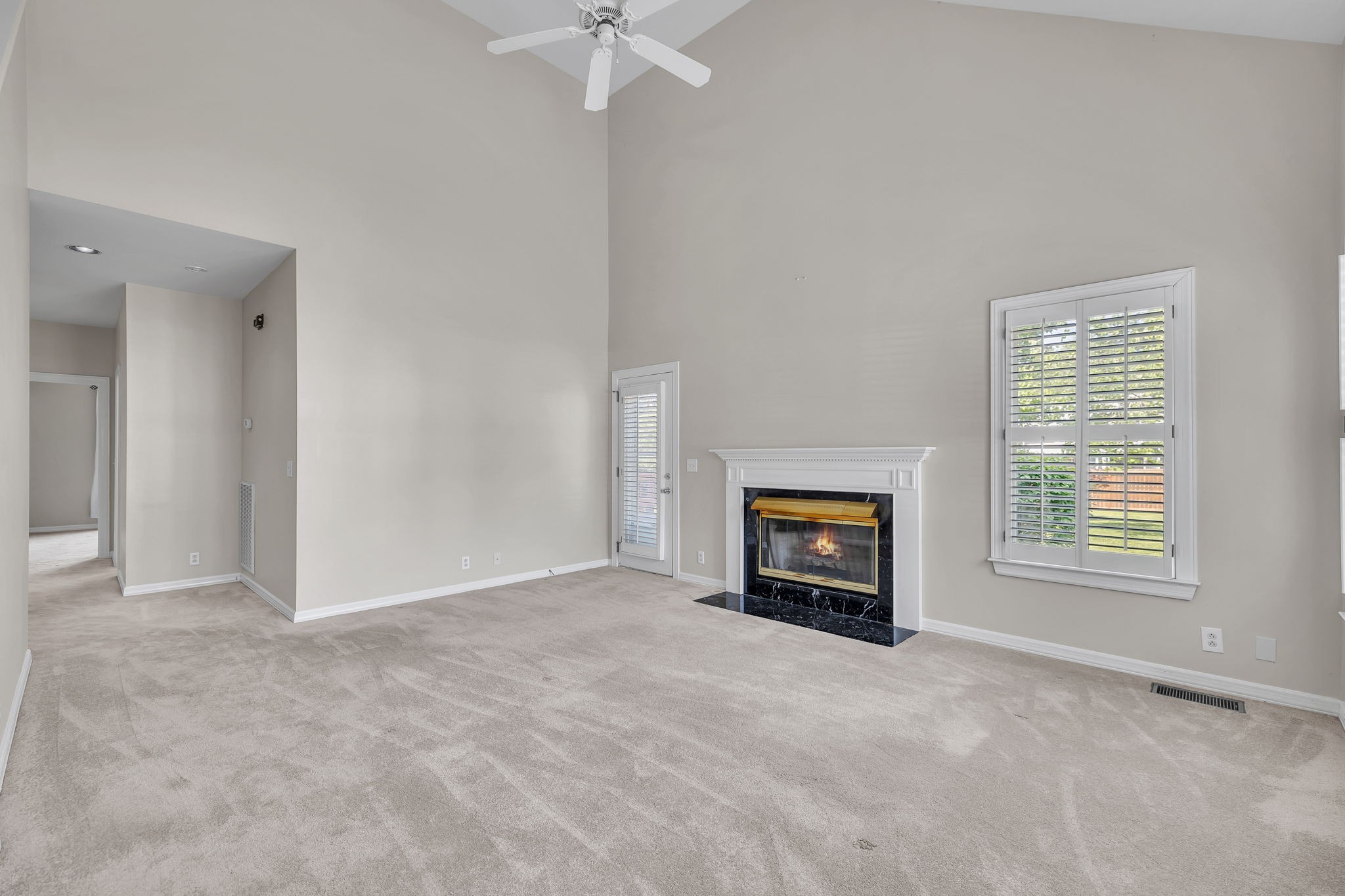 104 Hicks Road Nashville, TN 37221 - Photo 10 of 41 an empty room with a fireplace and windows