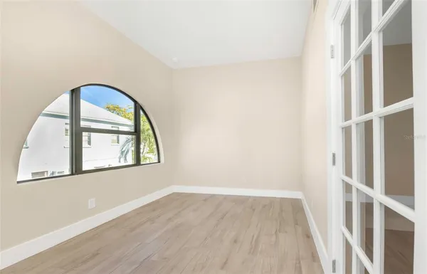 a view of room with window and wooden floor