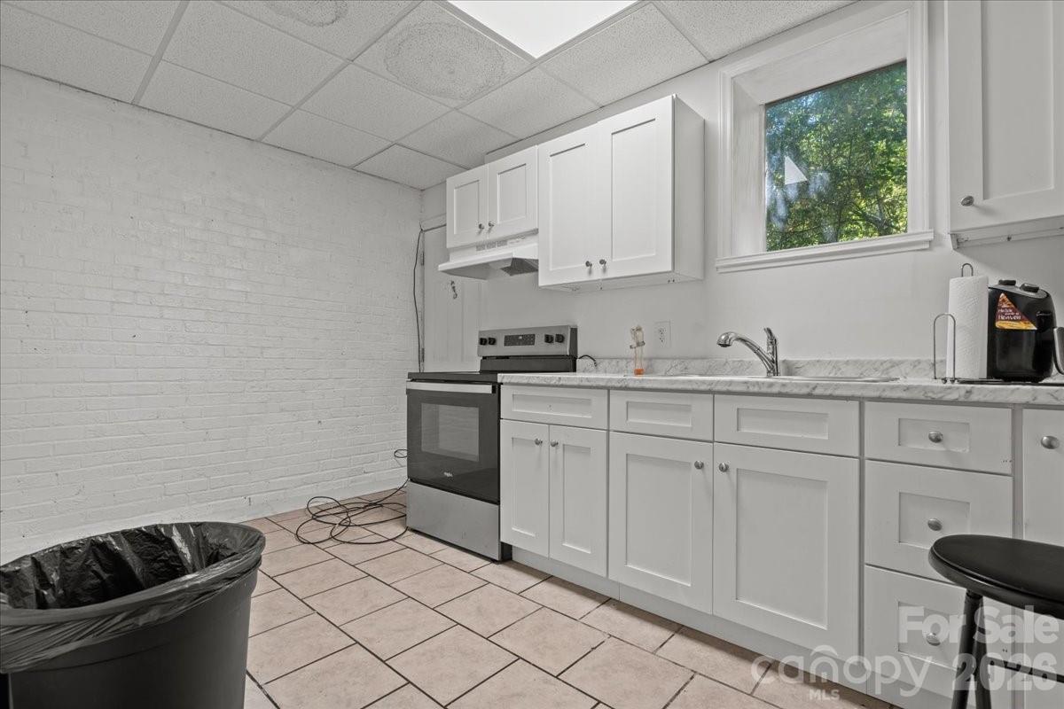 501 Church Street Cheraw, SC 29520 - Photo 13 of 48 a kitchen with white cabinets and sink