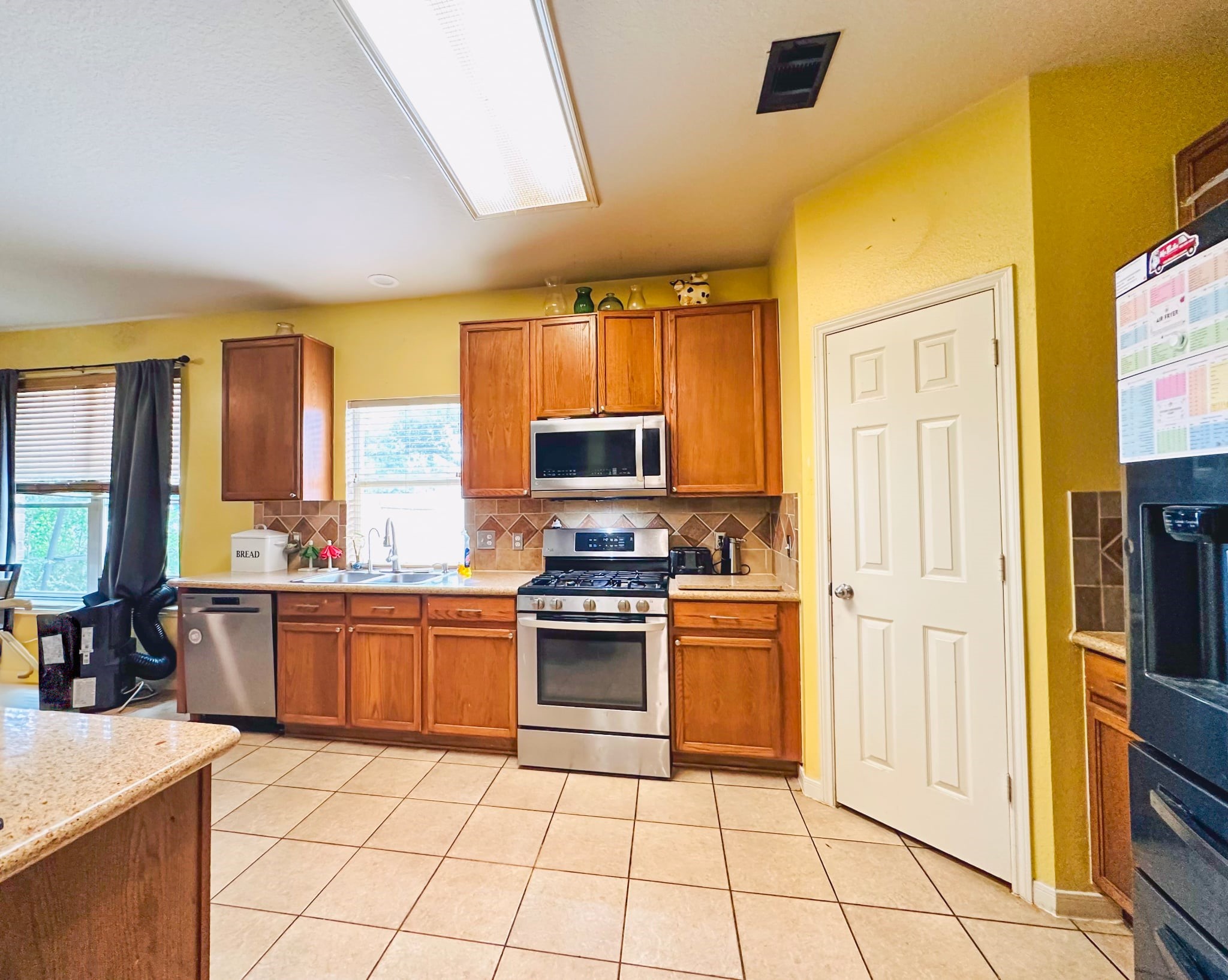 802 Cypresswood Bough Spring, TX 77373 - Photo 13 of 19 a kitchen with stainless steel appliances granite countertop a stove top oven a sink dishwasher and a refrigerator