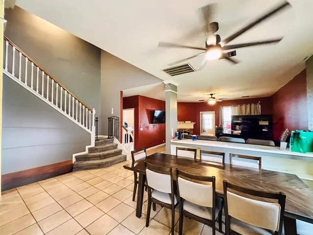 a kitchen with a table chairs and a chandelier