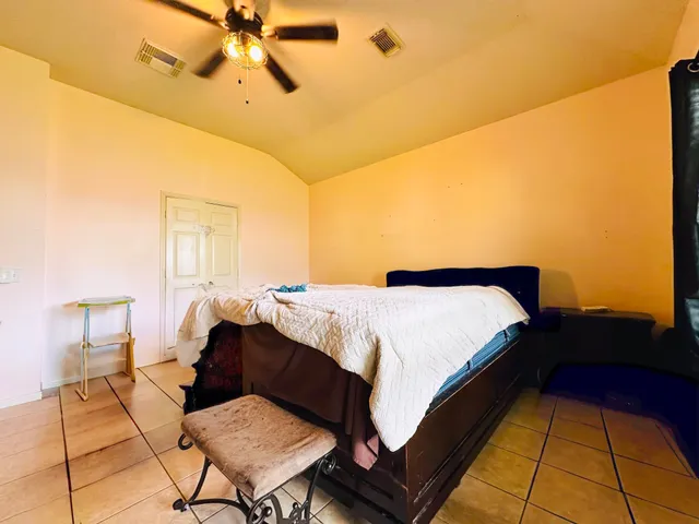 a bed room with a bed and a chair