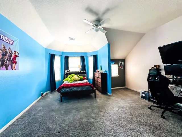 a bedroom with bed and a chandelier