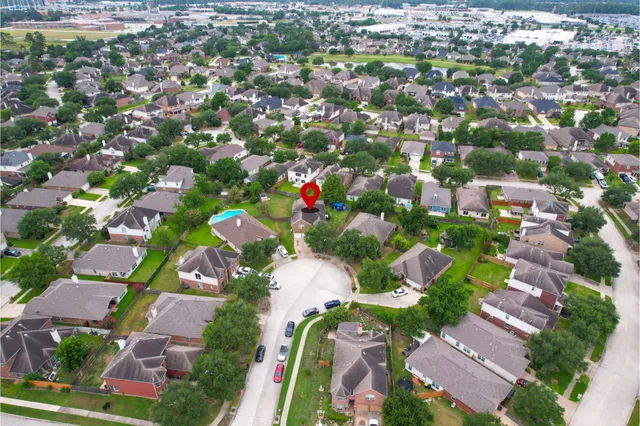 an aerial view of residential houses with outdoor space and street view