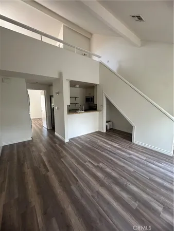 a view of a hallway view with wooden floor and staircase
