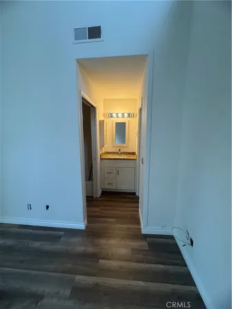 a view of a room with wooden floor and a window