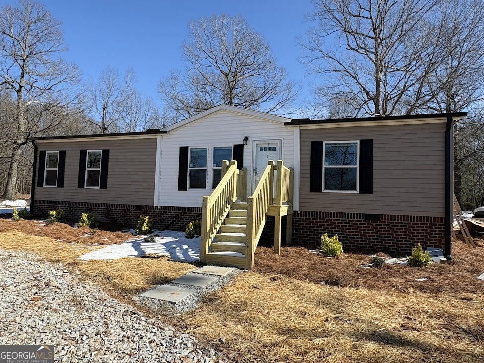 a view of a house with snow on the background