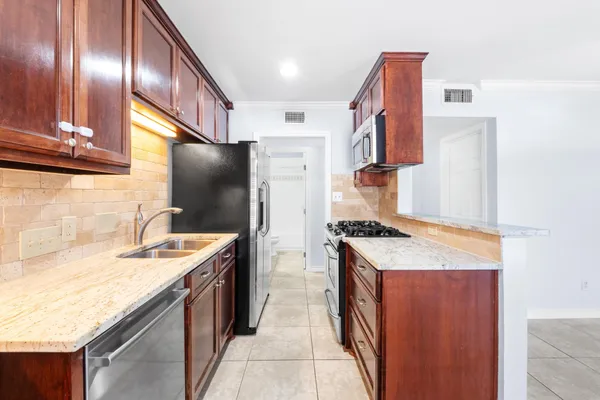 a kitchen with a sink stove and refrigerator