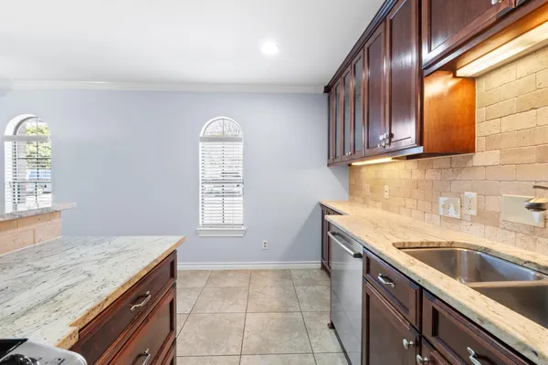 a kitchen with granite countertop a sink and a stove