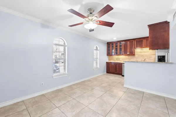 a view of kitchen with granite countertop cabinets and window