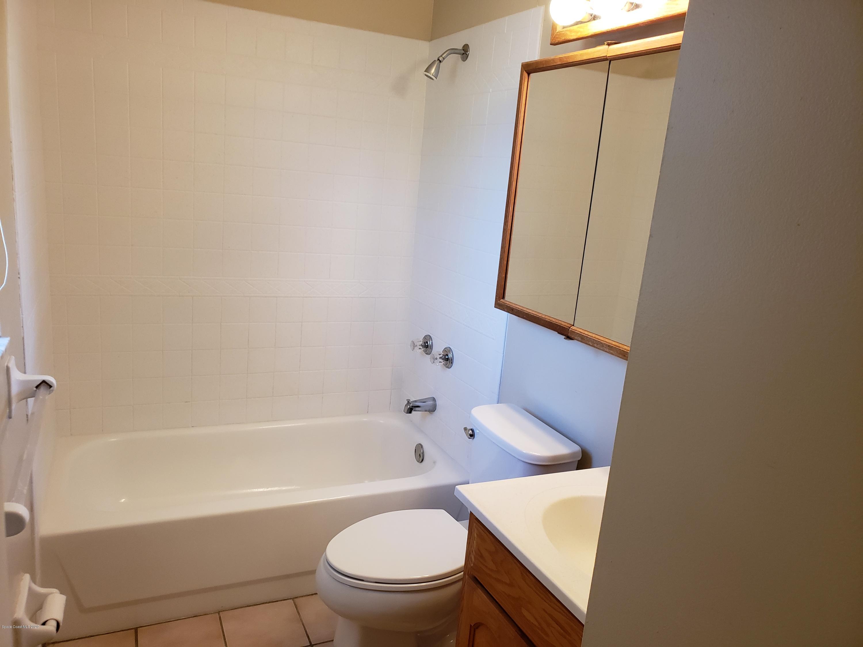 284 Jablo Avenue Cocoa, FL 32927 - Photo 14 of 20 a white bath tub sitting next to a white toilet