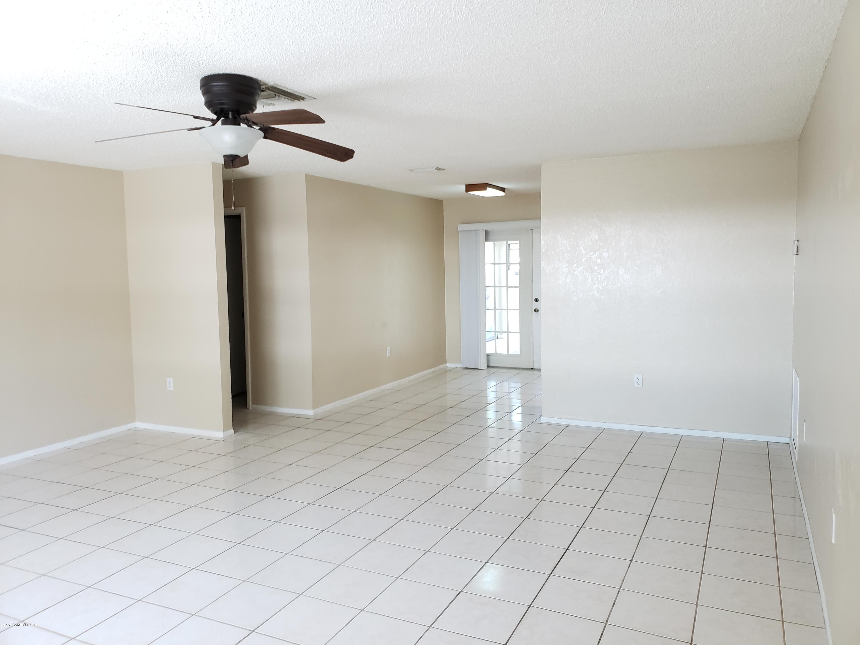 284 Jablo Avenue Cocoa, FL 32927 - Photo 6 of 20 a view of an empty room and chandelier fan