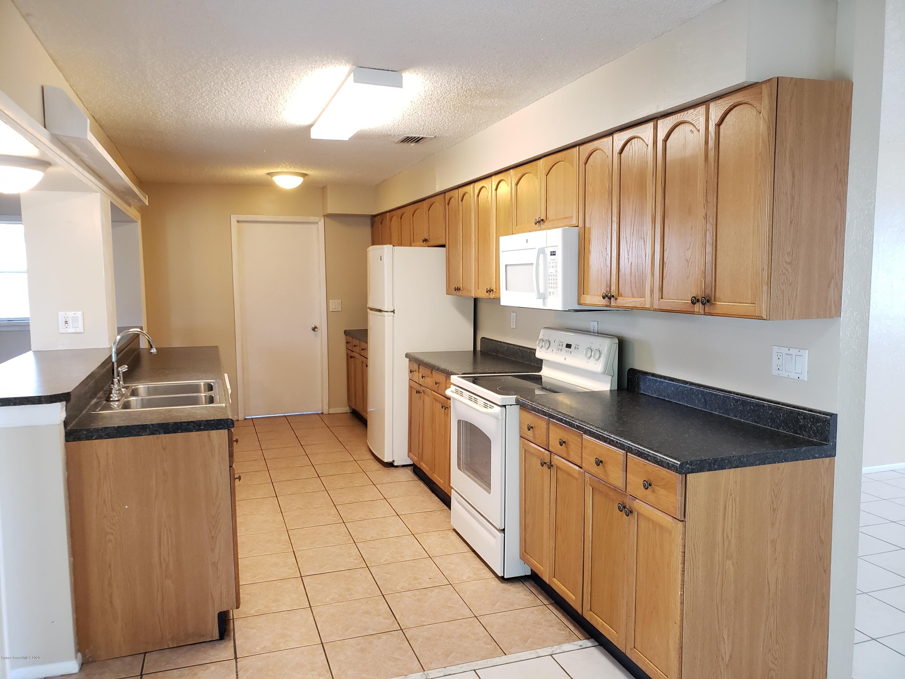 284 Jablo Avenue Cocoa, FL 32927 - Photo 7 of 20 a kitchen with stainless steel appliances granite countertop a sink stove and cabinets