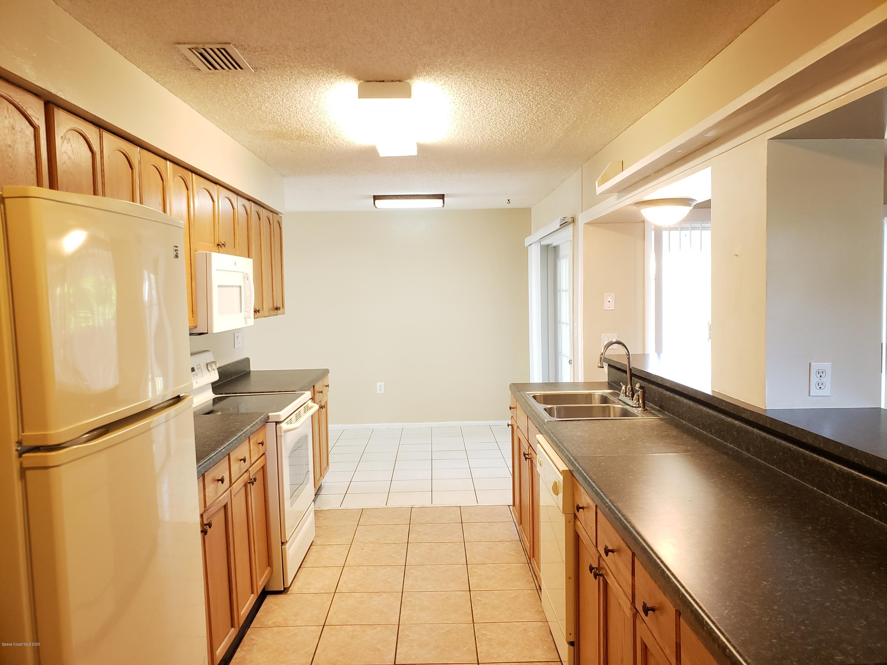 284 Jablo Avenue Cocoa, FL 32927 - Photo 9 of 20 a kitchen with a sink and a refrigerator