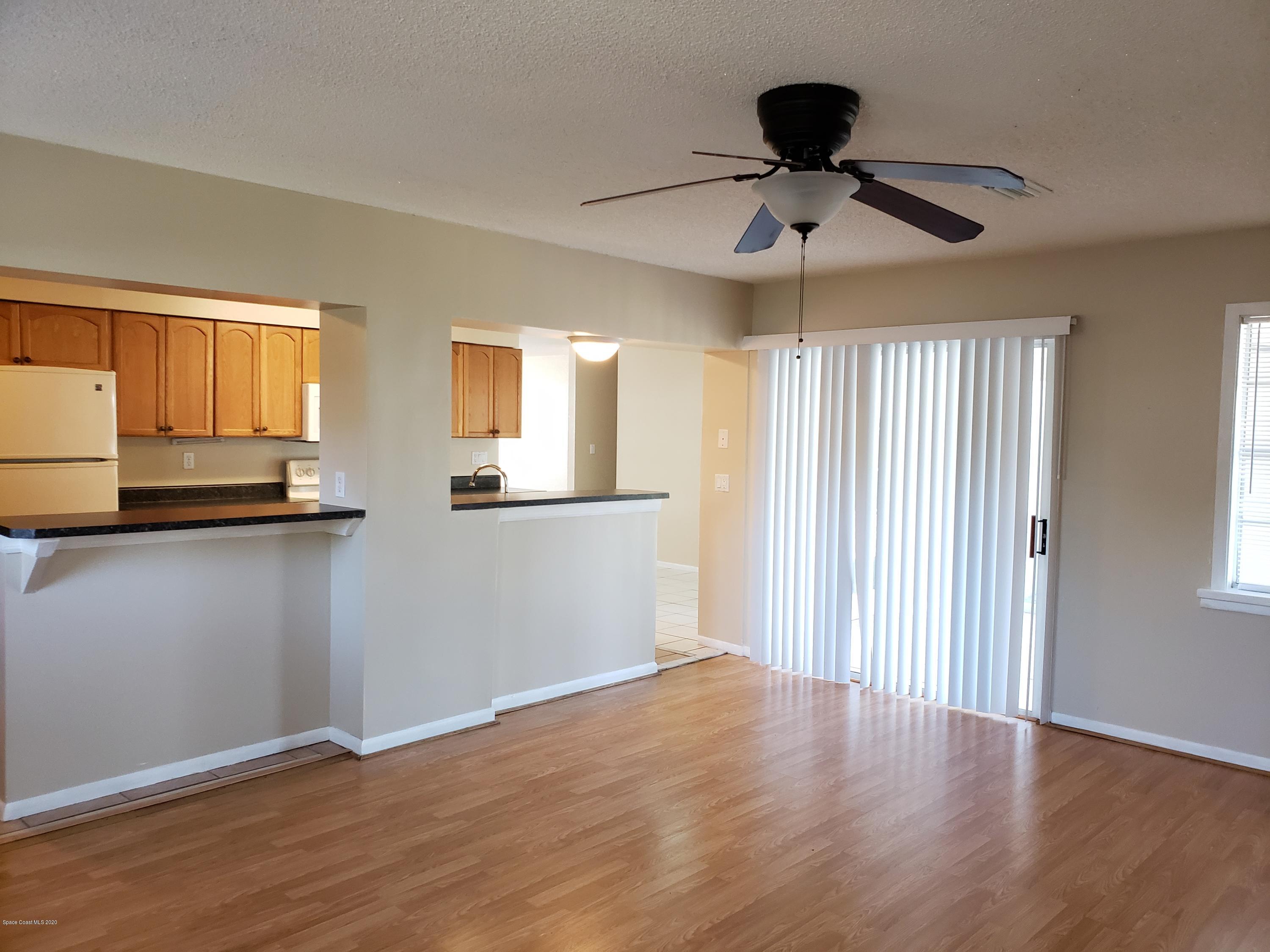 284 Jablo Avenue Cocoa, FL 32927 - Photo 10 of 20 a view of empty room with wooden floor and fan