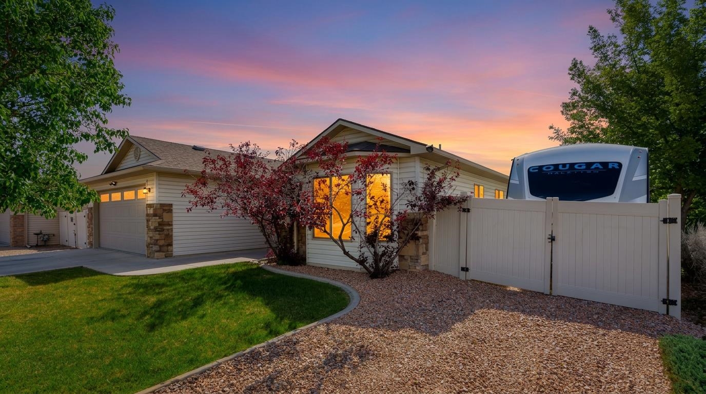 103 Red Rocks Street Fruita, CO 81521 - Photo 6 of 39 a view of a house with a small yard and a large tree