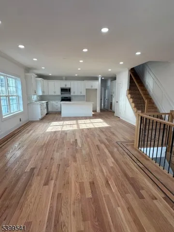 a view of kitchen with cabinets and wooden floor