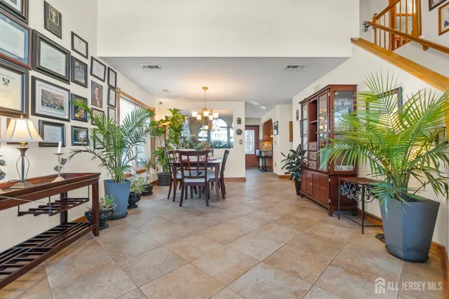 a dining room with furniture and a potted plant