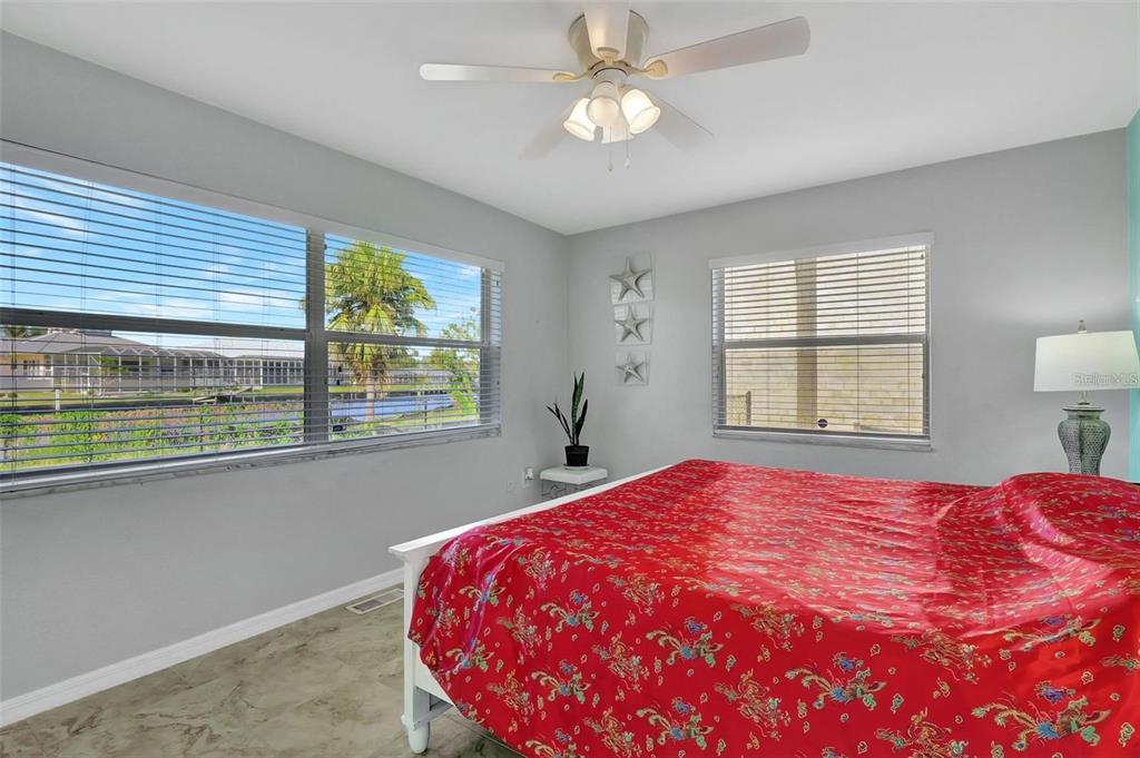 250 Bangsberg Road Southeast Port Charlotte, FL 33952 - Photo 15 of 59 a bedroom with a large bed and a window