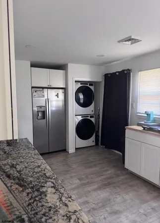 a kitchen with stainless steel appliances a refrigerator sink and stove