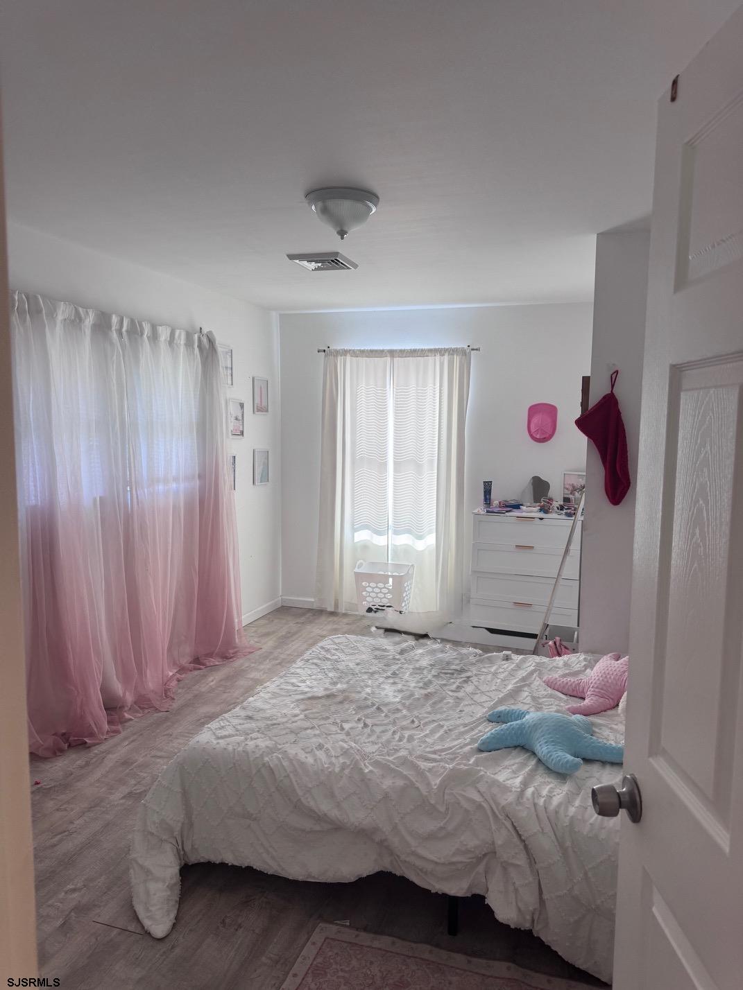 12 Colwick Drive Somers Point, NJ 08244 - Photo 5 of 8 a bedroom with a bed and a window