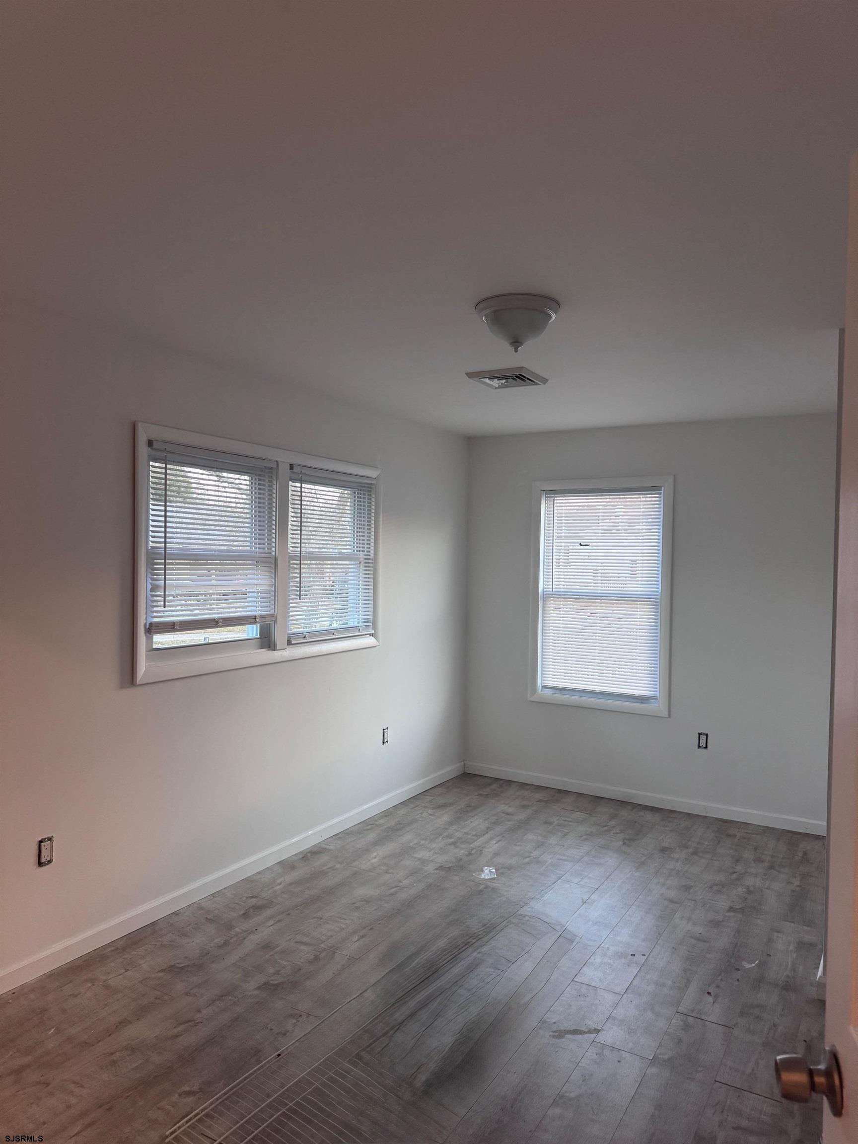 12 Colwick Drive Somers Point, NJ 08244 - Photo 8 of 8 wooden floor in an empty room with a window
