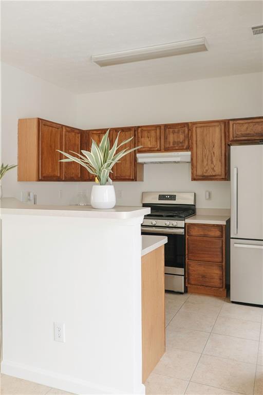 340 Timber Gate Court Lawrenceville, GA 30045 - Photo 12 of 26 a kitchen with granite countertop a refrigerator and a stove