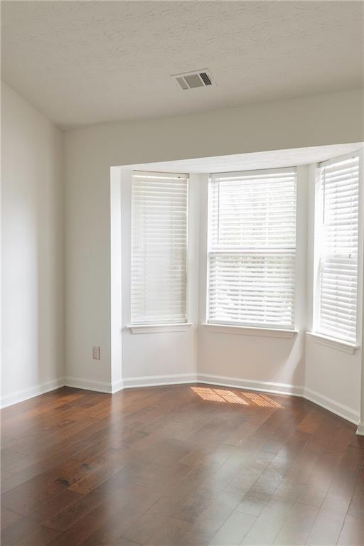 340 Timber Gate Court Lawrenceville, GA 30045 - Photo 15 of 26 an empty room with wooden floor and windows